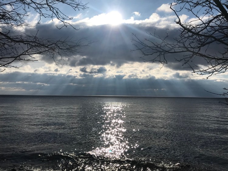 Sun streaming through clouds over Lake Superior.