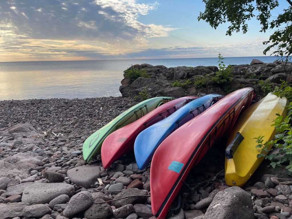Colorful kayaks sit on shoreline waiting for Sea Villa guests.